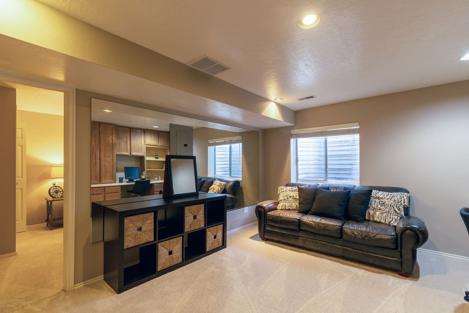 Finished basement living room with recessed lighting and cozy seating