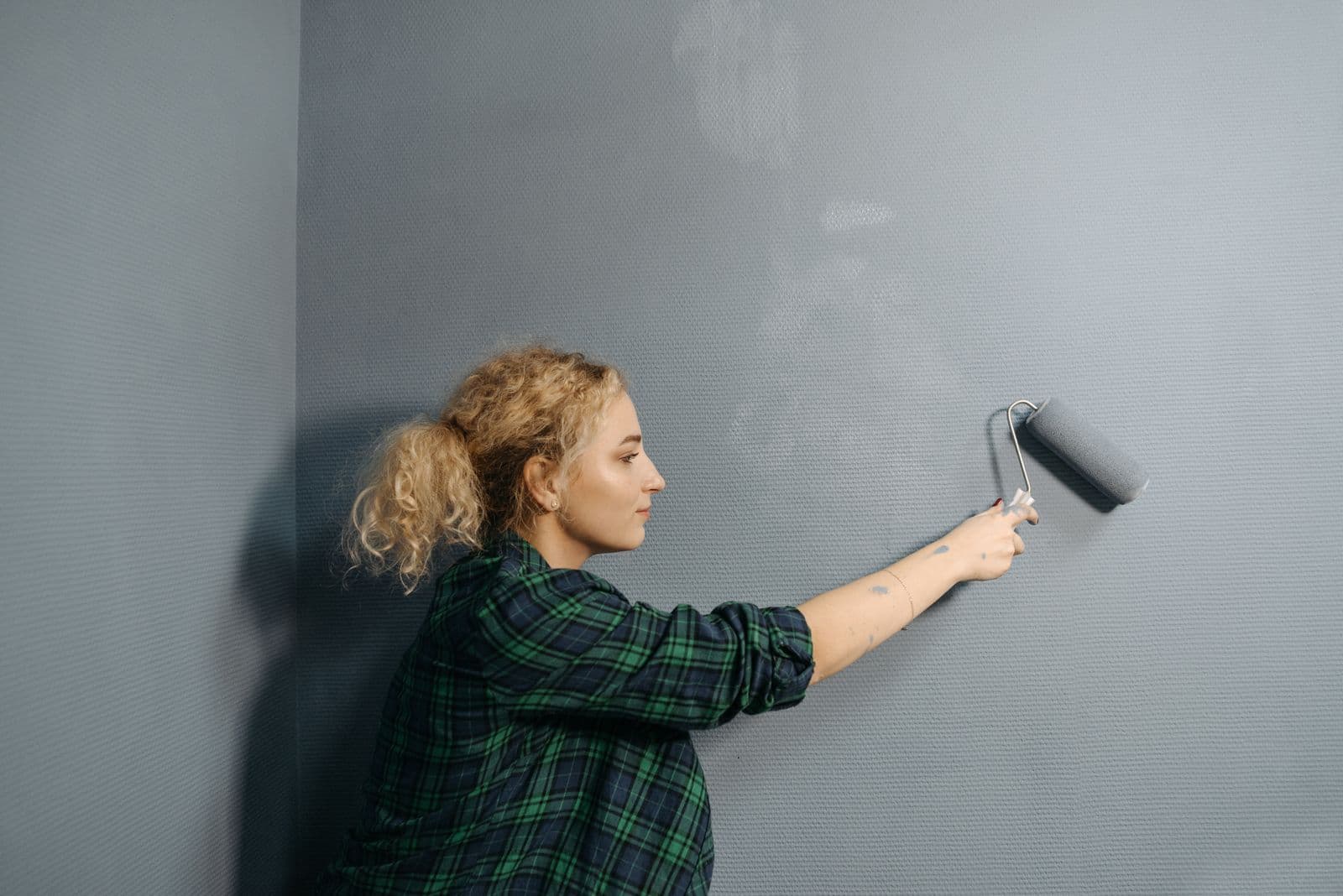 Painter finishing an interior wall